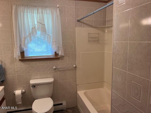 6331 Hyndaman Rd, Buffalo Mills, PA 15534 - full bath featuring a baseboard radiator, tile walls, vanity, and shower / washtub combination