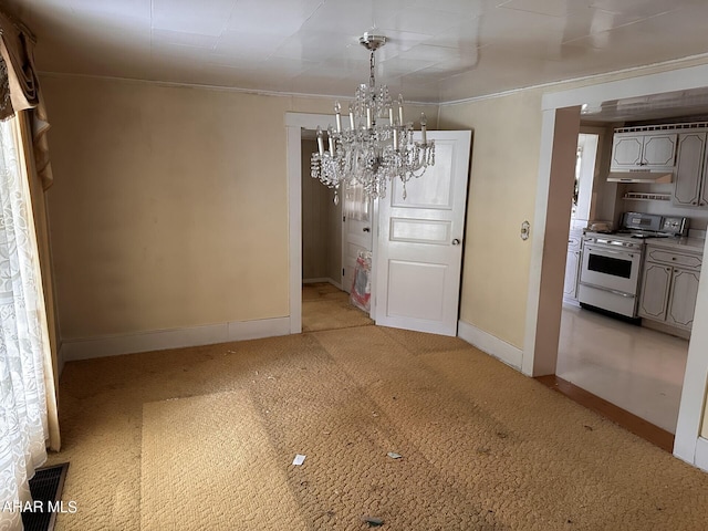 unfurnished dining area with ornamental molding, light colored carpet, and an inviting chandelier