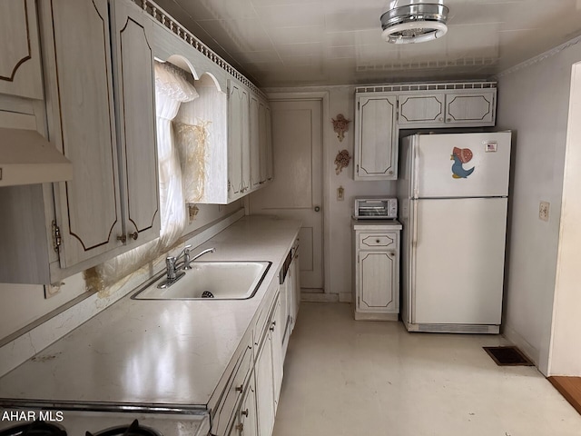 kitchen featuring sink and white refrigerator