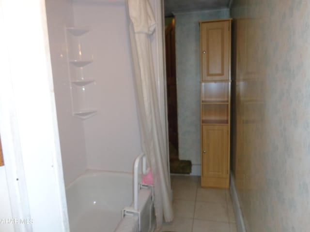 708 Blair St, Hollidaysburg, PA 16648 - bathroom with shower / tub combo with curtain and tile patterned flooring
