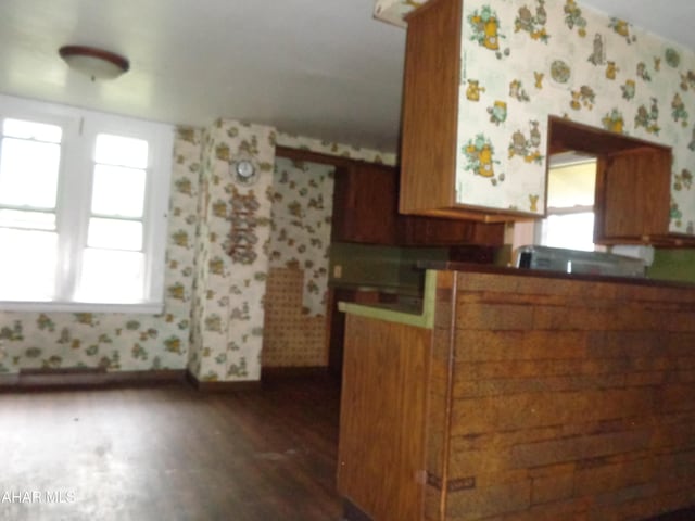 708 Blair St, Hollidaysburg, PA 16648 - kitchen with wallpapered walls, dark wood-style flooring, brown cabinetry, and plenty of natural light