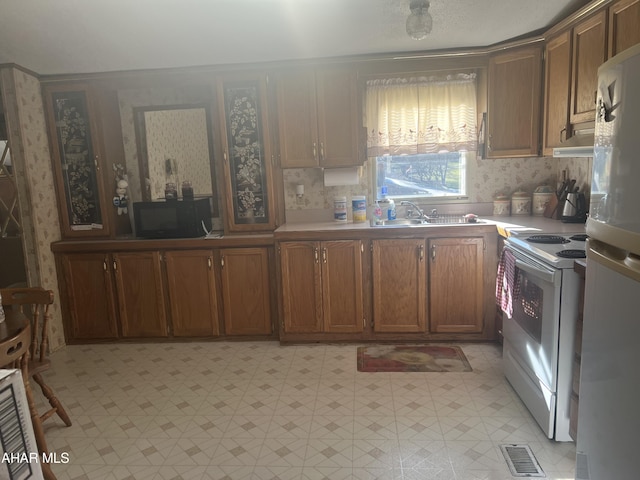 kitchen featuring white appliances and sink