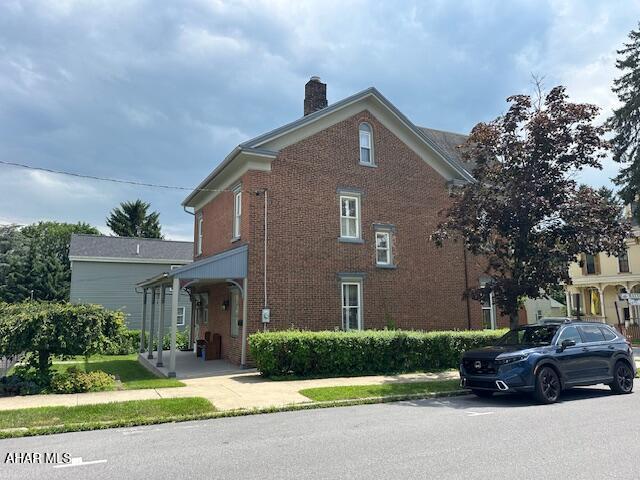 522 Wayne St, Hollidaysburg, PA 16648 - view of side of property with a chimney and brick siding