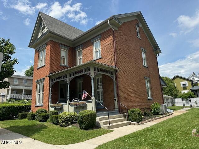 522 Wayne St, Hollidaysburg, PA 16648 - back of house with brick siding, a lawn, and a porch