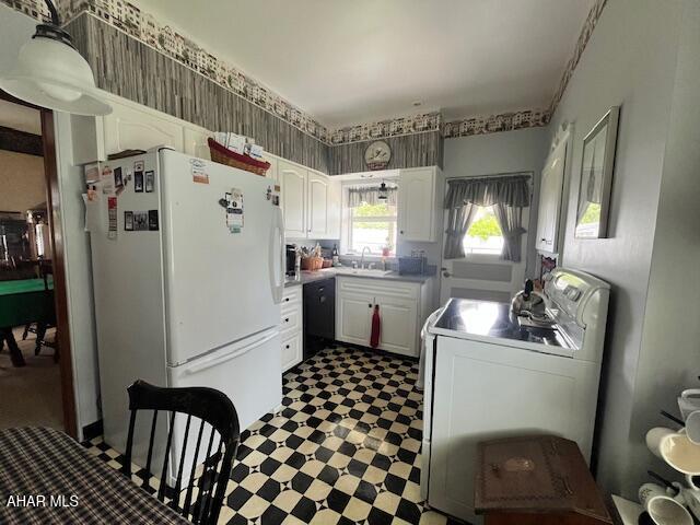 522 Wayne St, Hollidaysburg, PA 16648 - kitchen with freestanding refrigerator, stove, dark flooring, white cabinets, and washer / clothes dryer