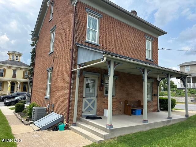 522 Wayne St, Hollidaysburg, PA 16648 - back of house with brick siding and a chimney