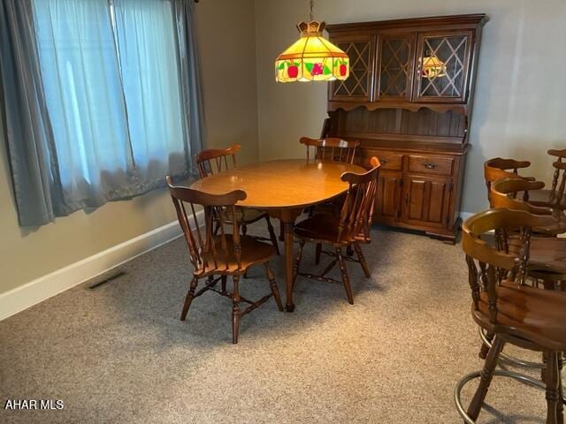 dining space featuring carpet flooring