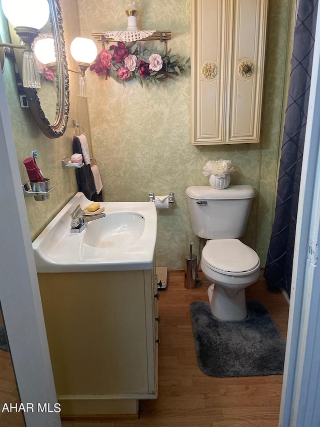 bathroom featuring hardwood / wood-style floors, vanity, and toilet