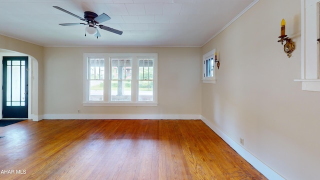 1113 Broadway, Altoona, PA 16601 - unfurnished room featuring wood finished floors, arched walkways, ceiling fan, and ornamental molding