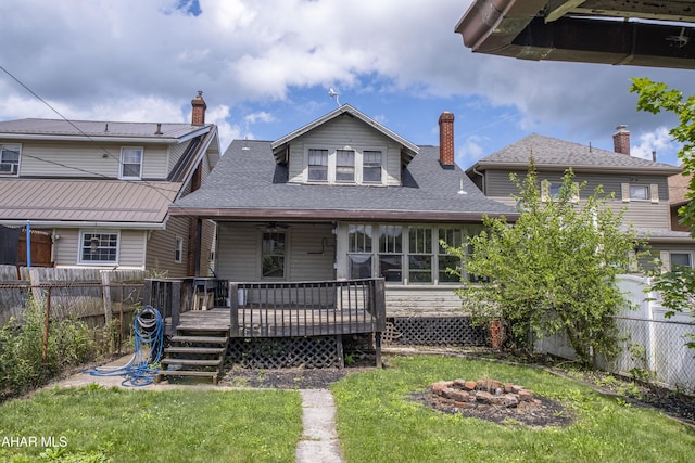 1113 Broadway, Altoona, PA 16601 - back of house with an outdoor fire pit, a fenced backyard, a deck, and a shingled roof