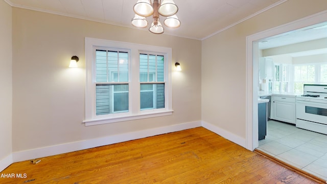 1113 Broadway, Altoona, PA 16601 - unfurnished dining area with a chandelier, ornamental molding, and light wood-style flooring