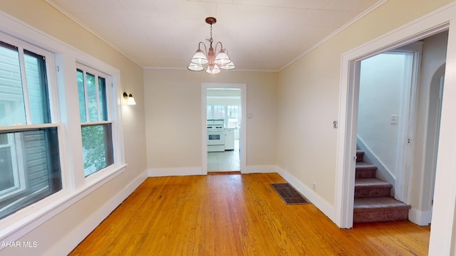 1113 Broadway, Altoona, PA 16601 - spare room featuring light wood-style floors, ornamental molding, a chandelier, and stairway