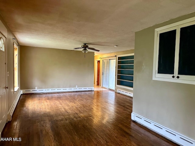 unfurnished room with hardwood / wood-style floors, a textured ceiling, and a baseboard heating unit