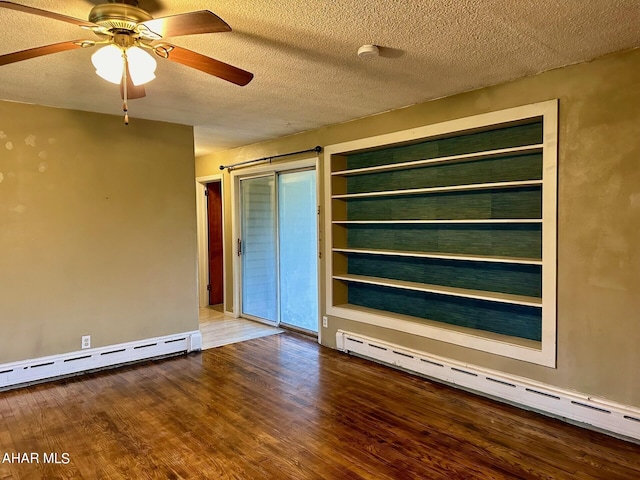 empty room with ceiling fan, wood-type flooring, a textured ceiling, and a baseboard heating unit