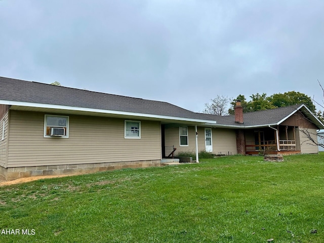 back of house with a lawn