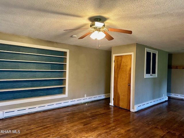 spare room featuring a textured ceiling, a baseboard radiator, and dark hardwood / wood-style floors