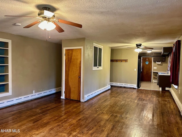 empty room featuring dark hardwood / wood-style flooring, a textured ceiling, and a baseboard heating unit