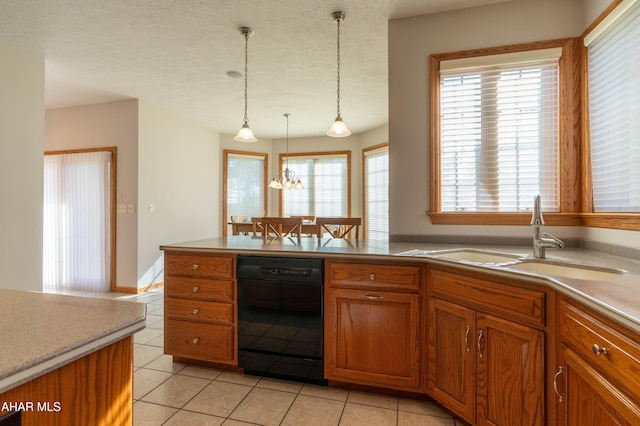 219 Scenic Pine Dr, Hollidaysburg, PA 16648 - kitchen featuring dishwasher, a sink, brown cabinets, light tile patterned floors, and a textured ceiling