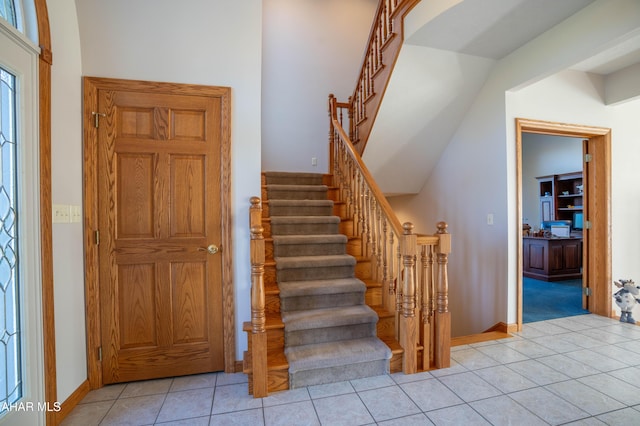 219 Scenic Pine Dr, Hollidaysburg, PA 16648 - staircase featuring tile patterned floors, baseboards, and lofted ceiling