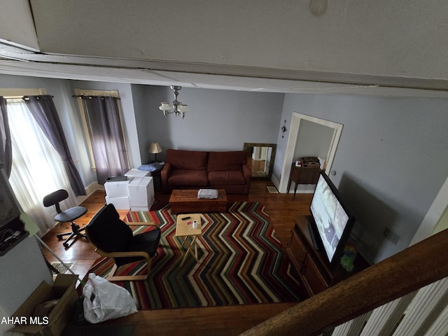 living room featuring a notable chandelier and wood finished floors