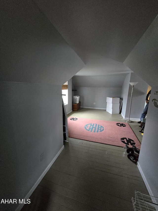 bonus room featuring baseboards, lofted ceiling, and hardwood / wood-style floors