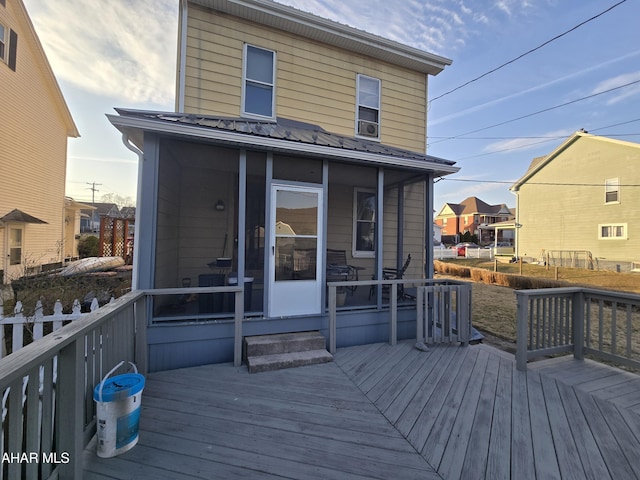 wooden deck with a sunroom