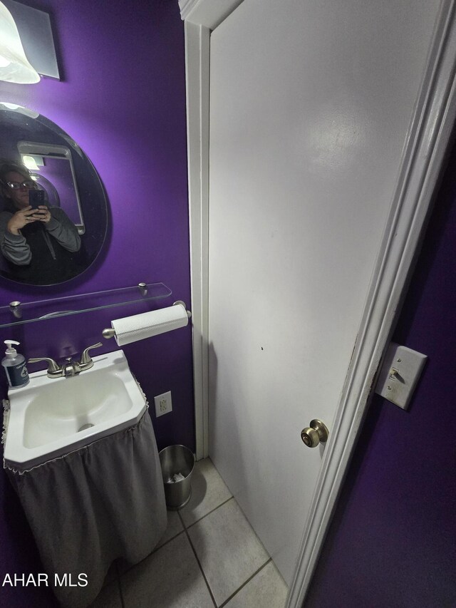 bathroom featuring tile patterned floors and a sink