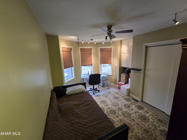 bedroom with rail lighting, baseboards, and ceiling fan