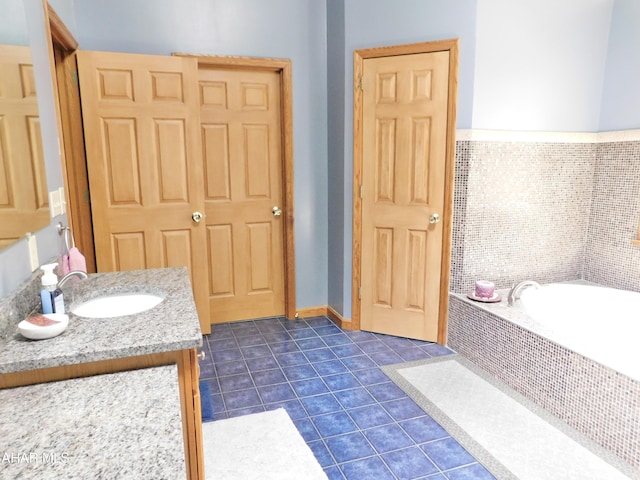 bathroom featuring vanity, tiled bath, and tile patterned floors