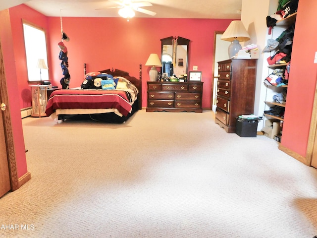 bedroom with carpet flooring, a baseboard radiator, and ceiling fan