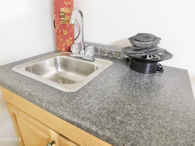 interior details featuring light brown cabinetry and sink