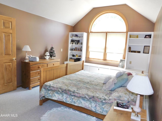 bedroom featuring light carpet and lofted ceiling