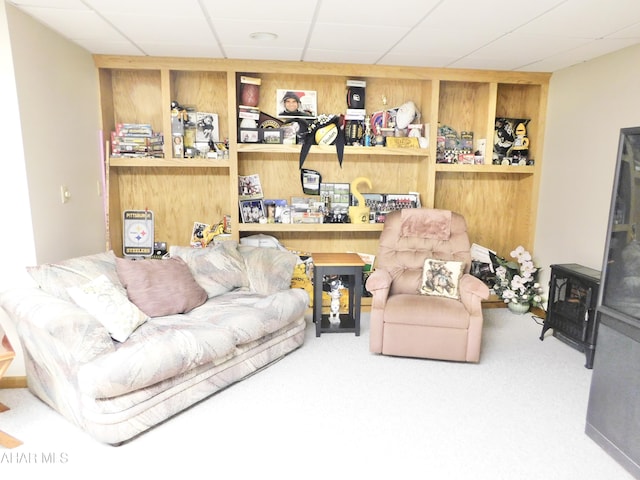 carpeted living room featuring a paneled ceiling