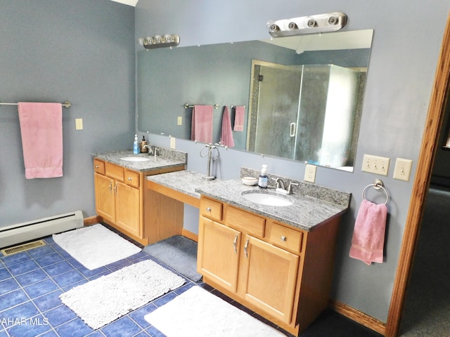 bathroom featuring walk in shower, vanity, tile patterned floors, and baseboard heating