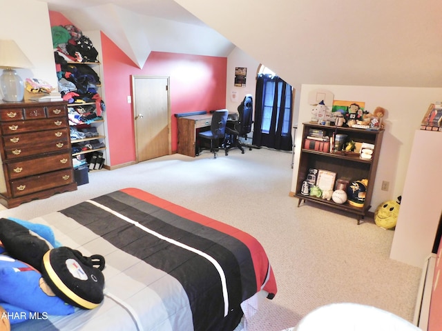 carpeted bedroom featuring lofted ceiling