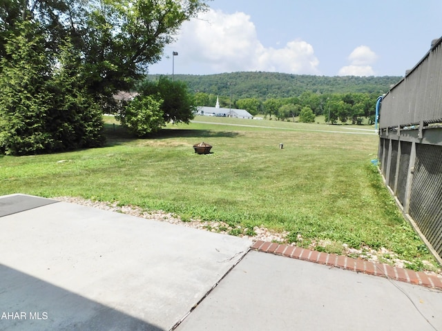 view of yard with a patio and an outdoor fire pit