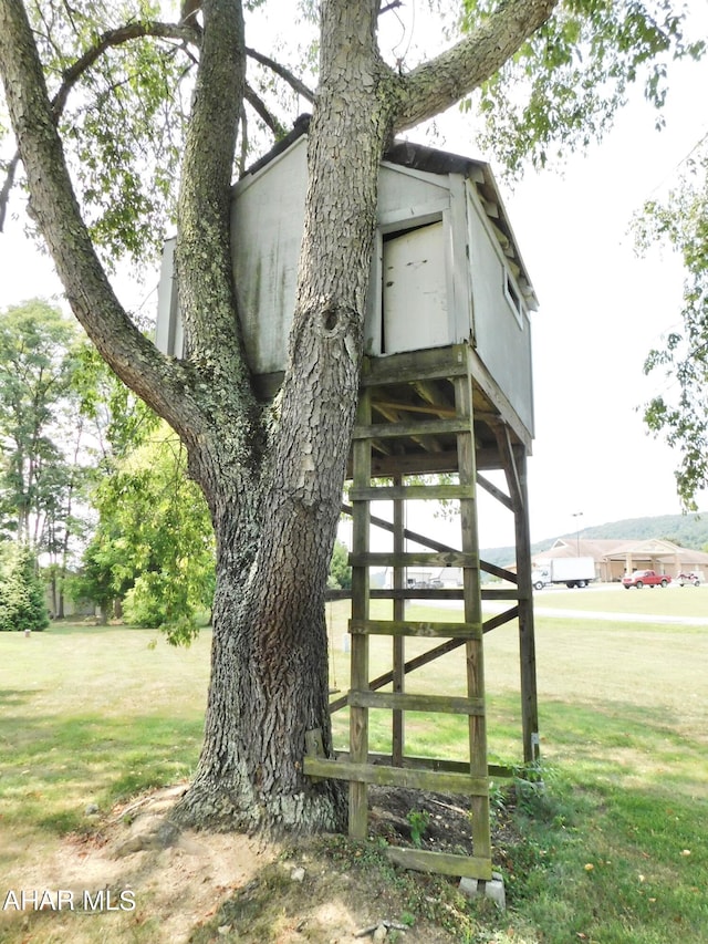 view of side of home with a lawn