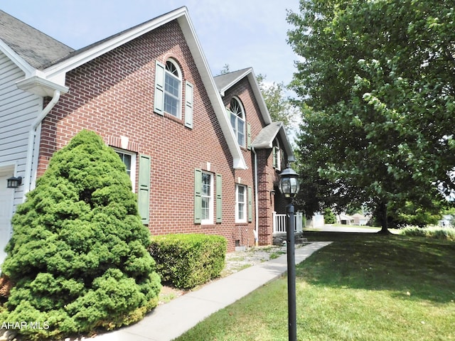 view of side of home featuring a yard