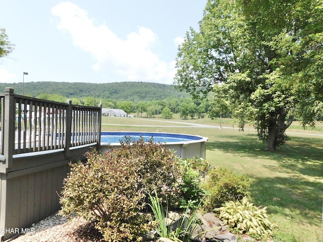 view of pool featuring a yard