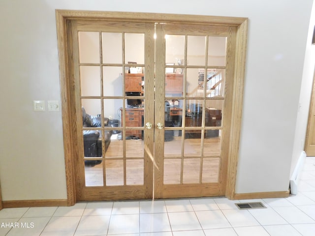 doorway to outside featuring french doors and light tile patterned floors