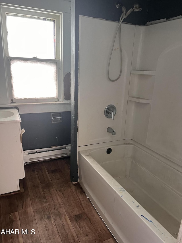 bathroom featuring shower / bathing tub combination, vanity, baseboard heating, and wood finished floors