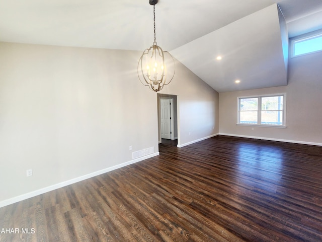 unfurnished room with dark hardwood / wood-style flooring, lofted ceiling, and an inviting chandelier