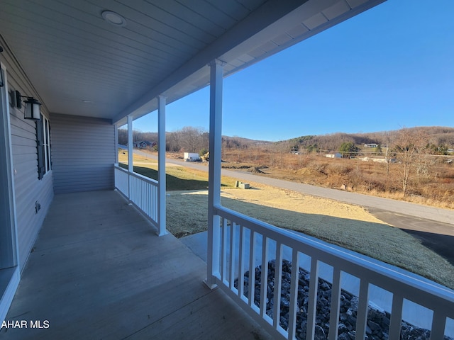 balcony with a rural view and a porch