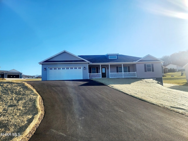 single story home featuring covered porch and a garage