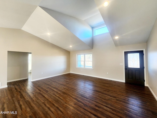 unfurnished living room featuring dark hardwood / wood-style floors and vaulted ceiling