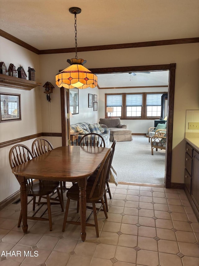 dining space with crown molding