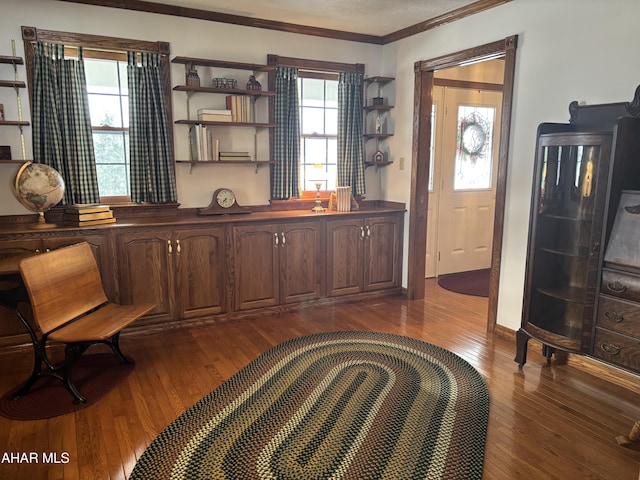 interior space with a wealth of natural light, crown molding, and dark hardwood / wood-style floors