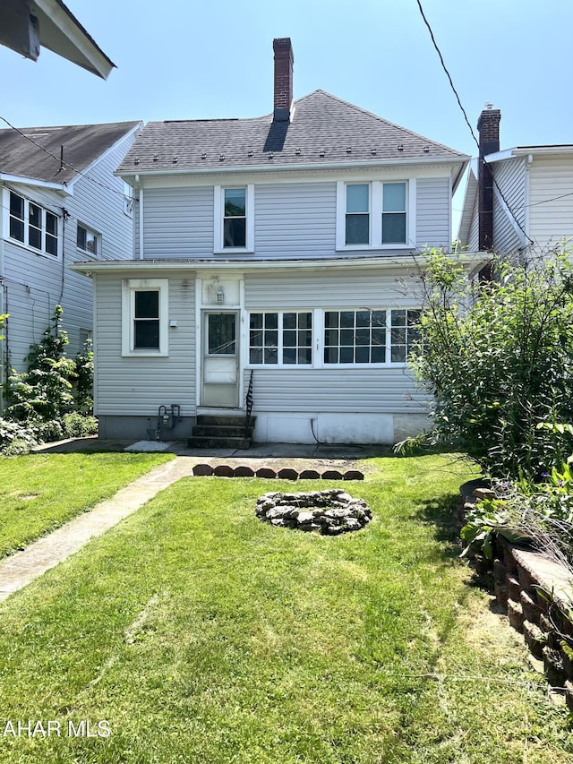 1008 N 3rd St, Altoona, PA 16601 - back of property featuring entry steps, a yard, and a chimney