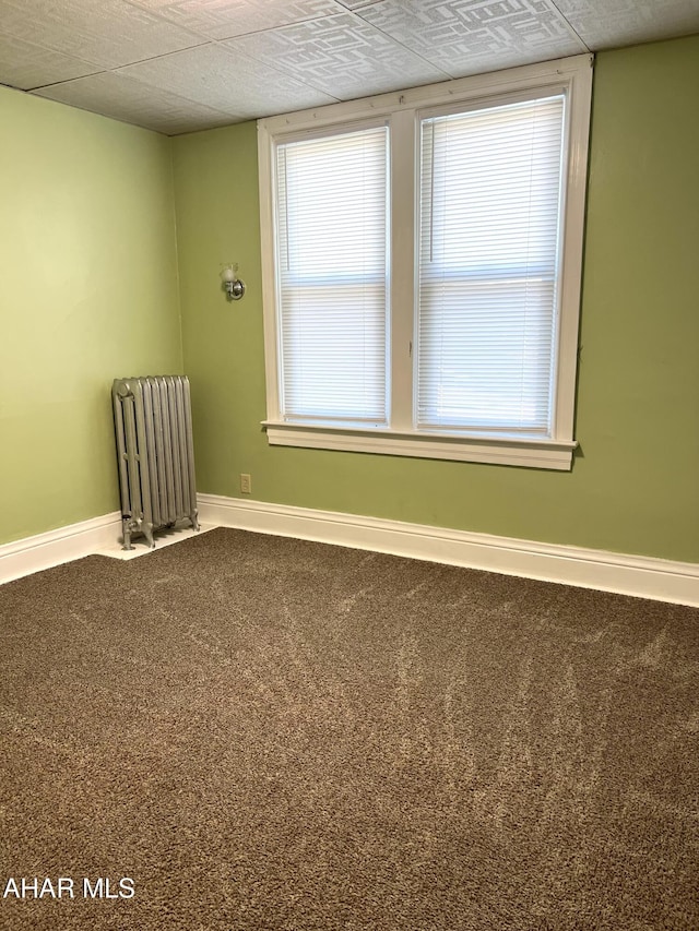 1008 N 3rd St, Altoona, PA 16601 - empty room featuring radiator heating unit and carpet
