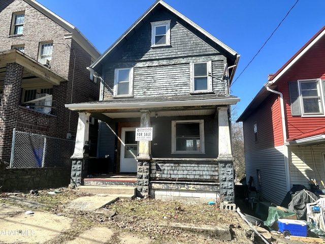 american foursquare style home with covered porch